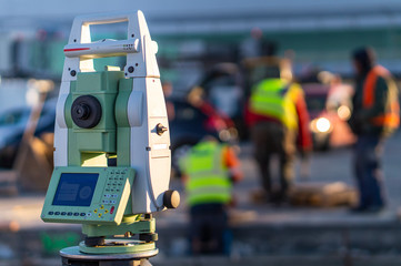 Surveyor equipment (theodolite) on construction site of the airport, building or road with...