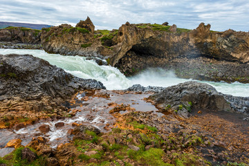 Water stream joying Skjalfandafljot river at downstream of Godafoss waterfall In Northeastern Iceland.