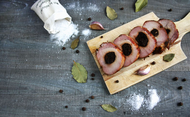 Baked pork chop with plum cut into slices surrounded by spices