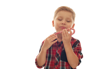 Little funny cute boy in a red checkered shirt