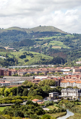 Naklejka premium Zarautz in the Basque Country, Spain, on a sunny day with the mountains in the background