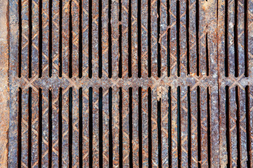 Sewer grate closeup top view. Old rusty iron texture