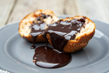 Homemade chocolate muffins in baking paper. grey plate.