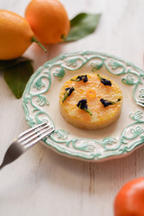 Lemon pie ornated with dry butterfly pea flowers served with fresh fruits on white background