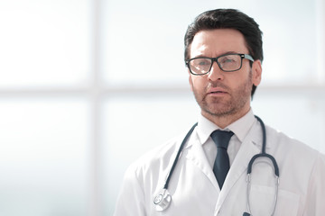 Portrait of a smiling doctor in a bright room of the clinic