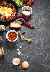 Shakshuka, Fried Eggs in Tomato Sauce in iron frying pan. Typical Israel food.