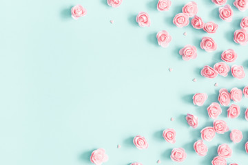Flowers composition. Pink rose flowers on pastel blue background. Valentines day, mothers day, womens day concept. Flat lay, top view, copy space