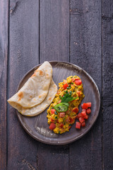Indian omelette with spices and tomatoes, copy space