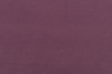 Fototapeta premium Close up bright purple cotton fabric texture background. Fashionable beautiful background. Selective focus. top view