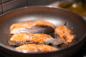 Salmon fry in pan. Cooking salmon steaks.