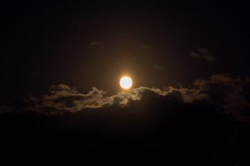 Moon through the clouds at night