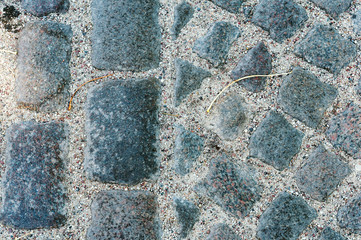 Fototapeta premium Cobblestones on the road. German paving stones. Neat paving stone.