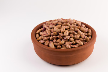 A plate of beans on white background