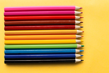 Coloured pencils isolated on the yellow background