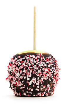 Low View Of Isolated Candy Apple Drizzled With Candy Cane Chips.