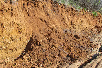 background of mudslide damage on dirt forest road