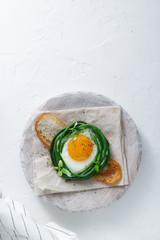 Fried egg with grean beans on toasted bread, copy space