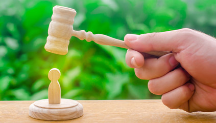 Machine repression and suppression of protests. The judge's gavel hovered over the human figure....