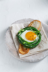 Green beans with sunny side fried egg on toast