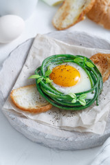 Green bean nest with fried egg on toasted bread