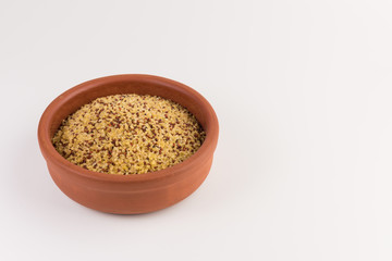 bowl of raw bulgur and quinoa isolated on white background