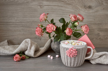 Valentines day still life with cup of hot chocolate with marshmallows, pink roses and greeting card