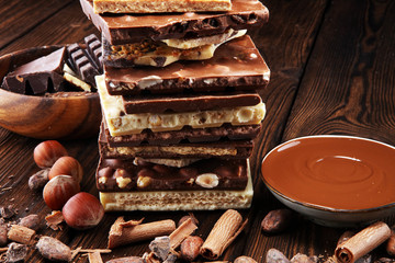 Chocolate bars on table with chocolate tower.