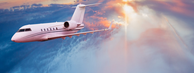 Naklejka premium Small private jetplane flying above beautiful clouds.