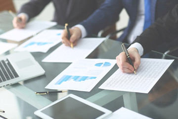 Obraz premium Audit concept at working with plan and analyzing investment charts at workplace