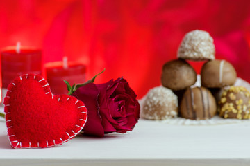 Valentine's day red background with roses and chocolate.