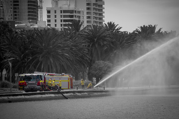 Fire brigade rescue practicing in Perth at the seaside in black and white and artistic coloration