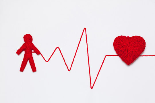 red yarn heart and human figure with thread like ECG pattern, isolated on white background
