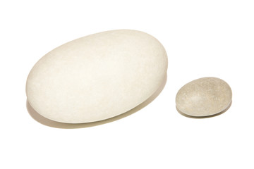 Two elongated stones. Big white and small grey stones. Isolated on white background.