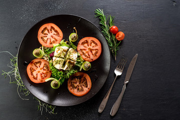 A dish from goat cheese and vegetables on black