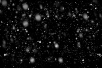 Snowfall on black background. Snow bokeh texture