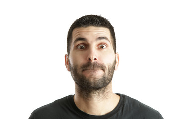 Fototapeta premium Studio shot of a young bearded man making a facial expression
