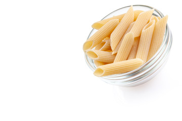 Raw feathers macaroni in bowl. Italian pasta close up, isolated on the white background