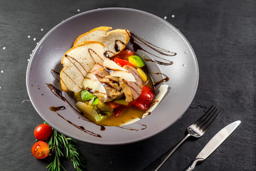 A mix with meat and vegetables on black background