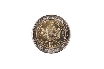 A close up image of a bimettalic Argentinian one peso coin isolated on a white background