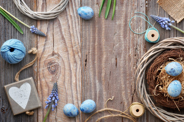 Easter background with eggs, blue hyacinth flowers and  wooden heart, top view on rustic wood, copy-space