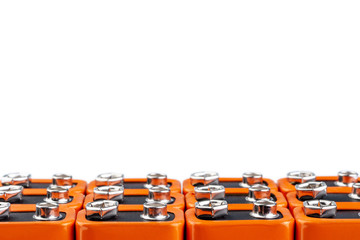 Many orange batteries, stand in several rows.  Isolated on white background.