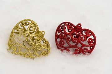 Close up of love symbols. Two nice hearts laying in white winter snow