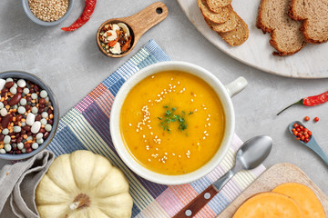 Pumpkin, mixed beans and sweet potato creme soup in ceramic bowl, top view with ingredients