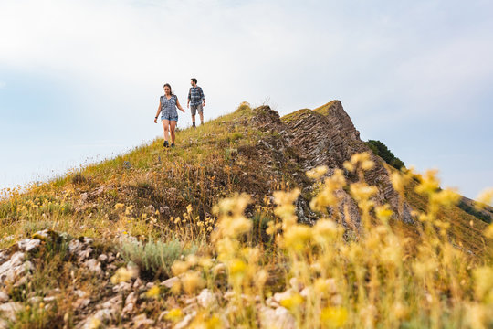 Couple Walking And Hiking At Mountains In Spring