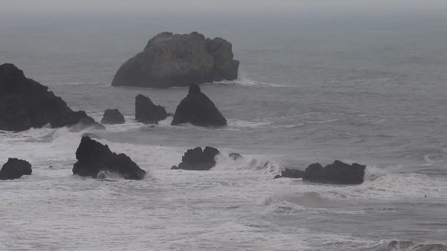 The Pacific Ocean. Swirling waves are on Pacific ocean after rain, Goat Rock Beach, Sonoma County, California winter.