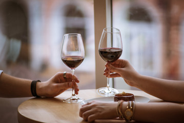 lovers boy and girl hold glasses in their hands in a cafe 2