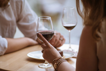 lovers boy and girl hold glasses in their hands in a cafe 3