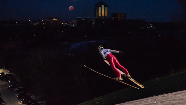 People are doing ski jump under the blood wolf moon