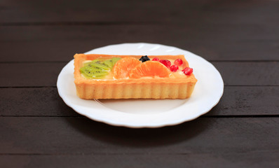 Healthy dessert with sweet cakes and fruits on a wooden table