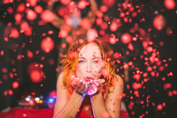 Happy woman throwing confetti in disco club - Young girl having fun moments celebrating in bar - People, nightlife, nightclub and youth holidays concept